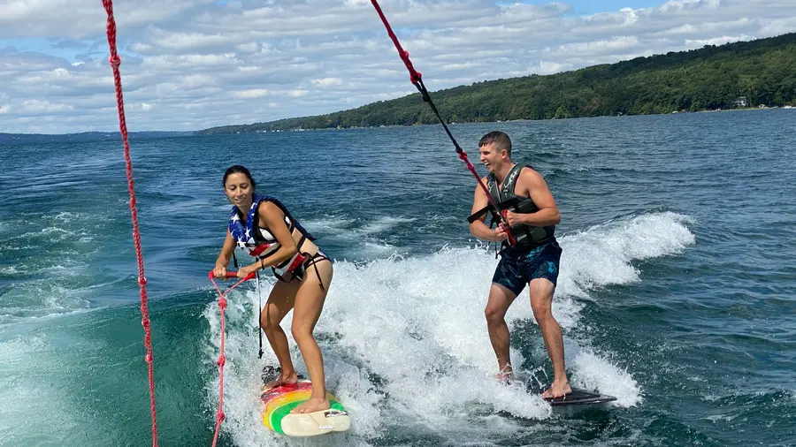 Two riders sharing the same surf wake