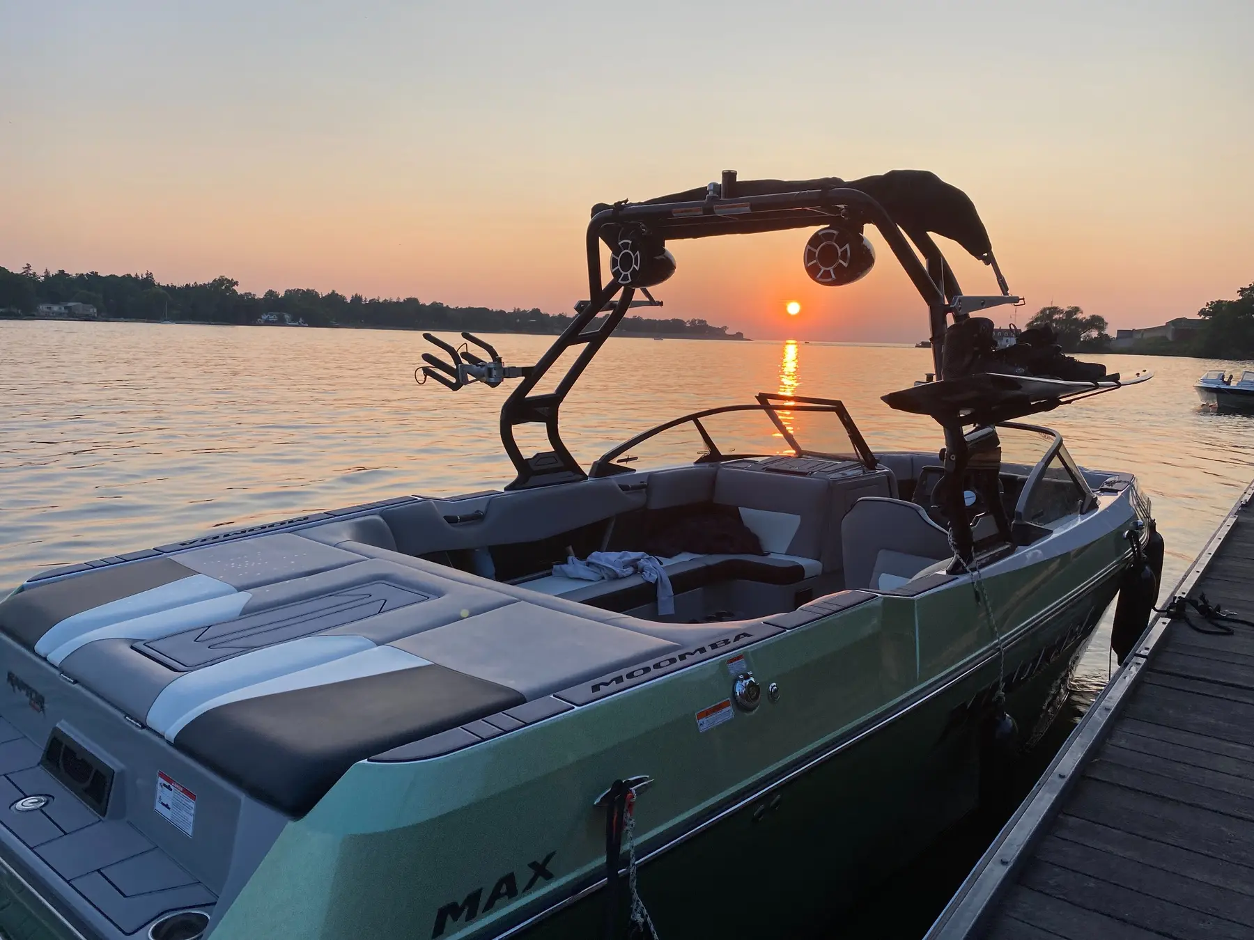 Modern Moomba Max wake boat docked at sunset